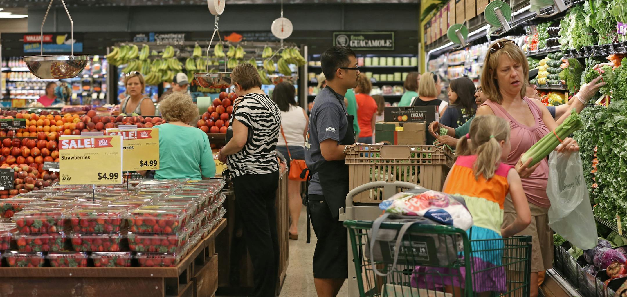 (at right) Lisa Norcross and her daughter Evelyn (age-61/2), from Plymouth, shopped the produce as Whole Foods opened a new Maple Grove store Wednesday, 7/17/13, at the Shoppes at Arbor Lakes. The national chain, which opened two stores in the Twin Cities in the mid-1990s and then did nothing expansino wise until about 2011, will soon have six stores here, as a new Minneapolis store is expected to open its doors in September.] Bruce Bisping/Star Tribune bbisping@startribune.com Lisa Norcross, Ev