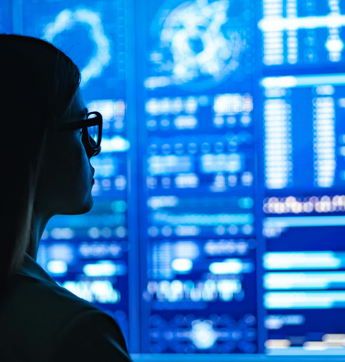 The businesswoman standing near the blue display