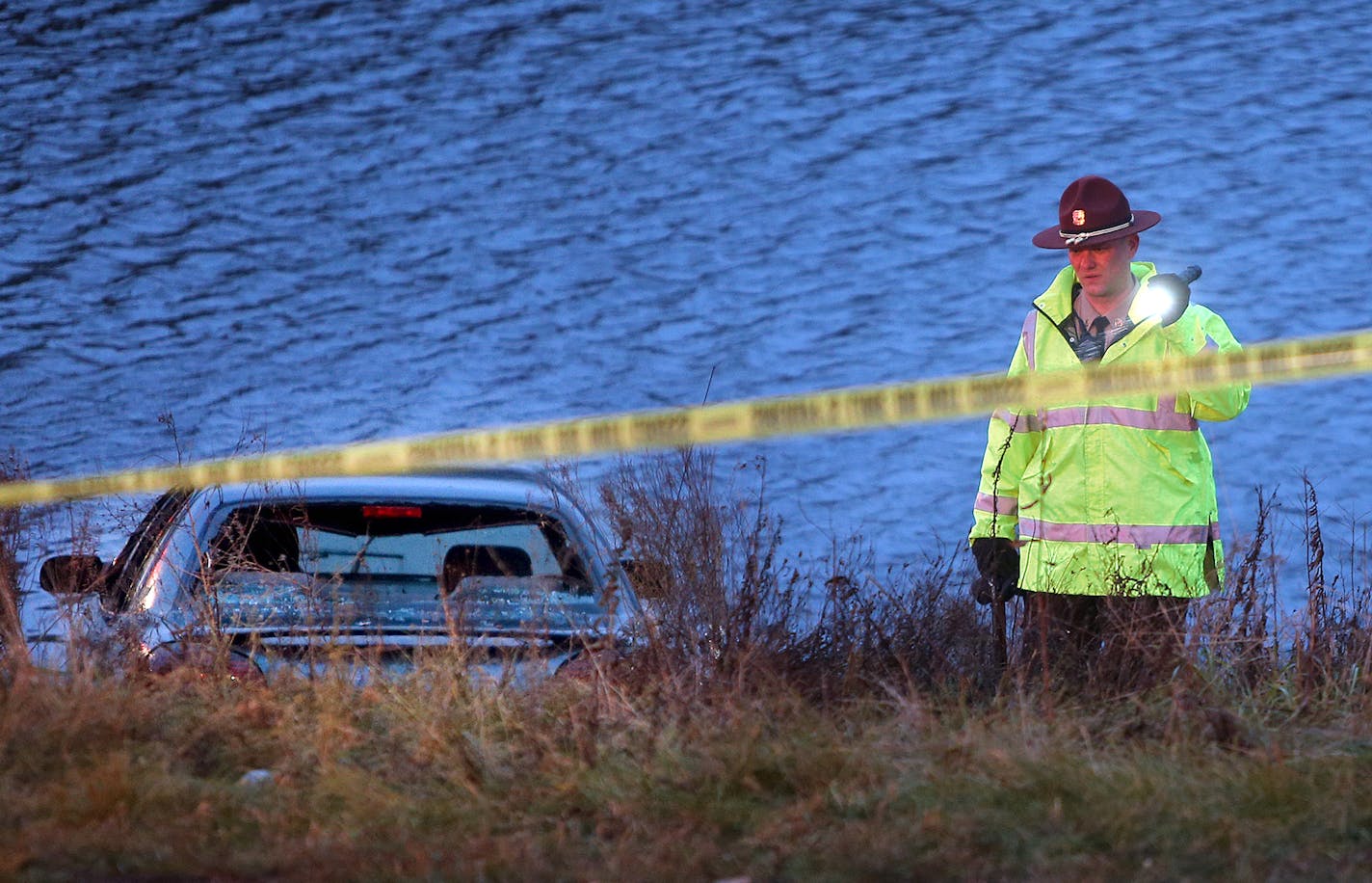 Police investigate the scene where six people were rescued after their car went into a holding pond near the Hwy 100 exit ramp going northbound on Hwy 7, Thursday, November 21, 2013 in St. Louis Park, MN.