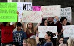 Protesters attend a rally at the Federal Courthouse in Fort Lauderdale, Fla., to demand government action on firearms, on Saturday, Feb. 17, 2018. The