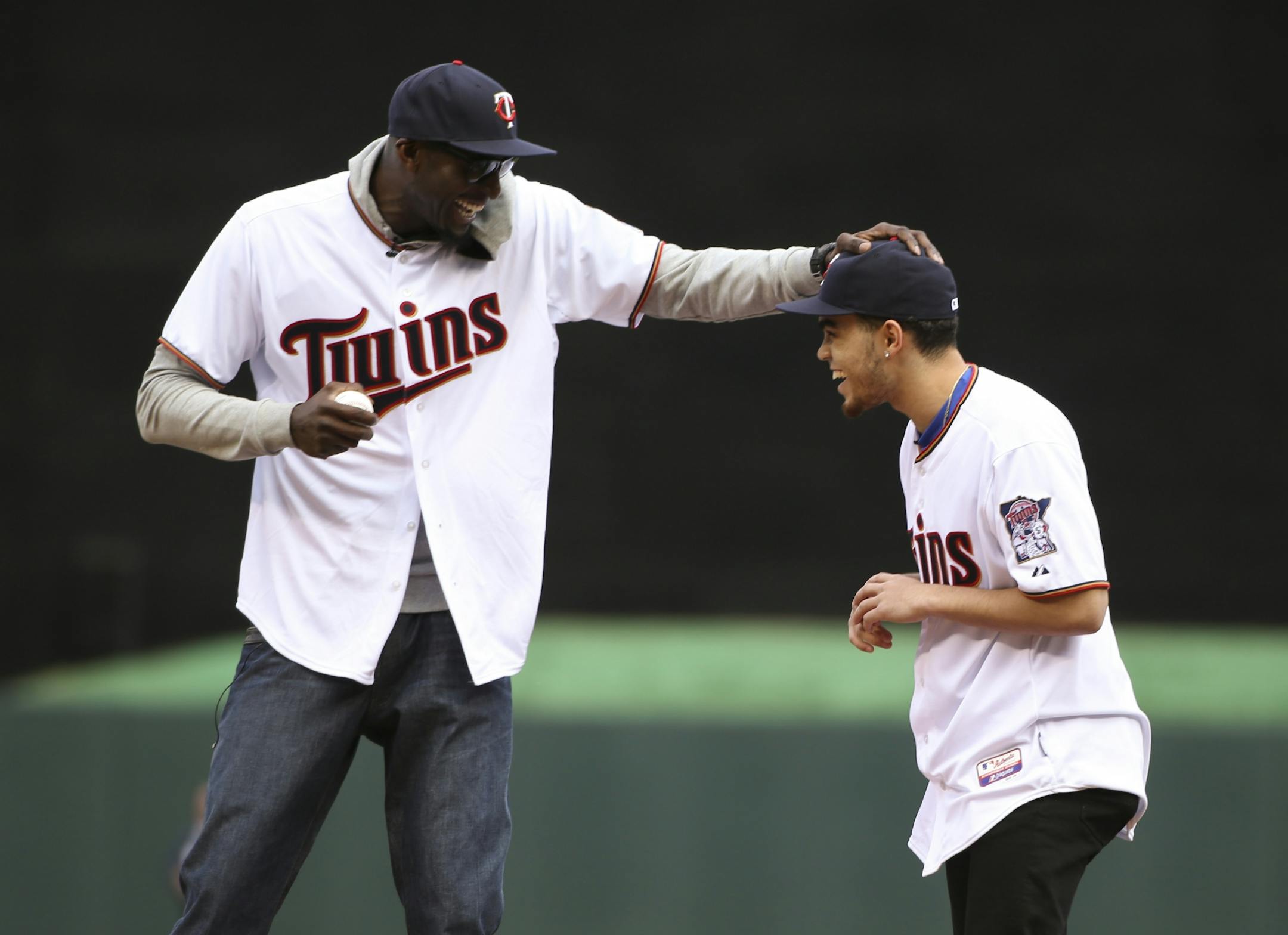 Duke and Apple Valley's Tyus Jones brought a baseball out to the Timberwolves' Kevin Garnett so he could throw the ceremonial first pitch before the game Monday afternoon at Target Field.