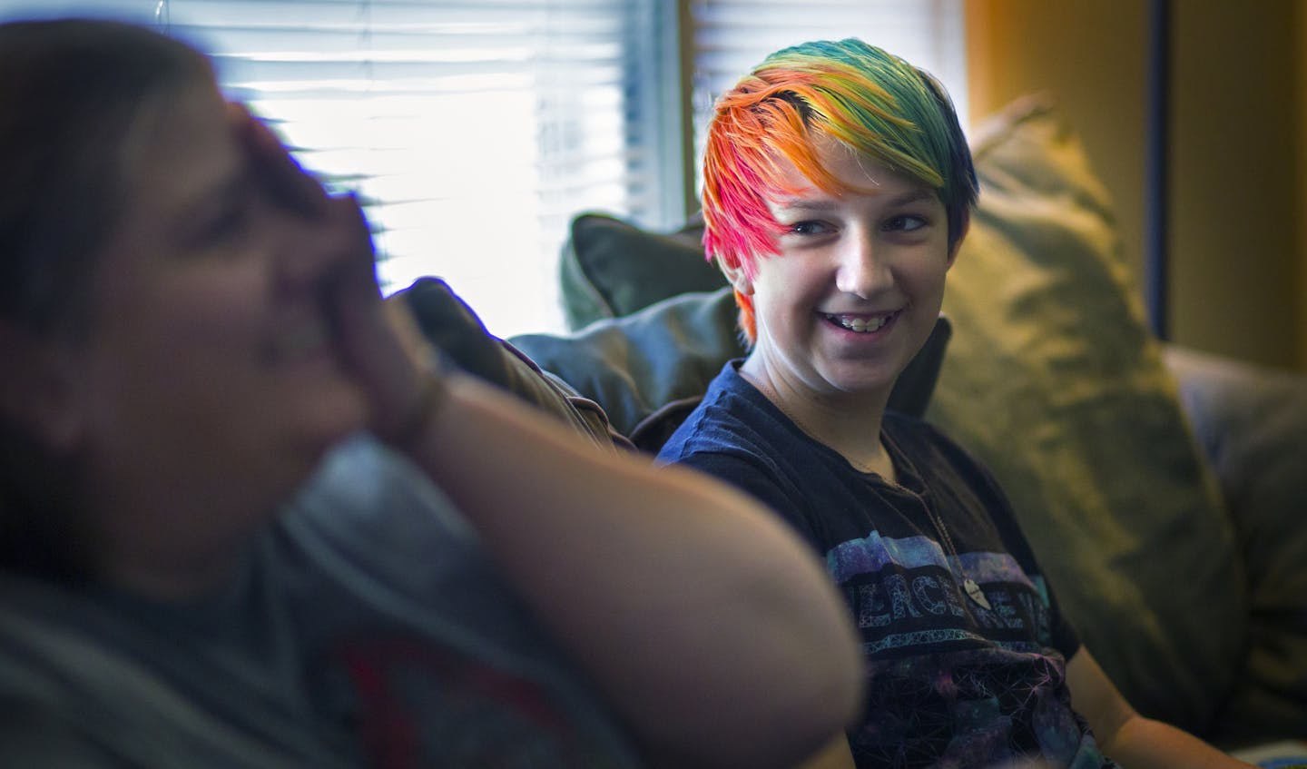 12-year-old George Dunkelberger at home with his mother Alison Yocom. George is transgender and recently died his hair a rainbow color for the recent pride parade. ] Their insurance company was at first unwilling to cover medication to delay puberty for George, but they eventually won. Brian.Peterson@startribune.com Minneapolis, MN - 7/20/2015