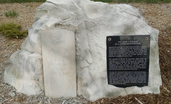 A new memorial plaque in Richfield explains how a typo (shown on the original headstone) accidentally sent Union sharpshooter John Dolson’s bones to