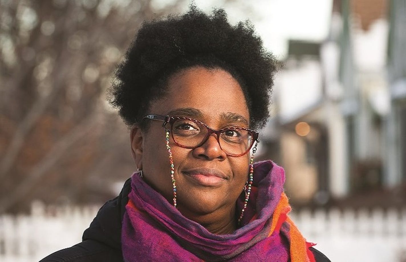 photo of author Taiyon Coleman in front of a fence