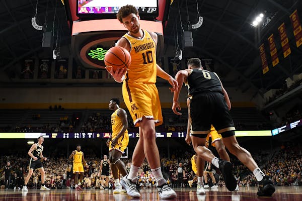 Gophers forward Jamison Battle (10) is dejected after allowing a dunk by Boilermakers forward Mason Gillis (0) during the first half Thursday’s game
