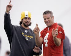 FILE - Green Bay Packers quarterbacks Aaron Rodgers, left, and Brett Favre talk during NFL football practice in Green Bay, Wis., Jan. 16, 2008. The Pa