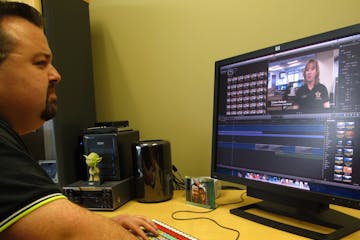 Justin Atkinson, a producer for South Washington County Telecommunications Commission, edits a video.