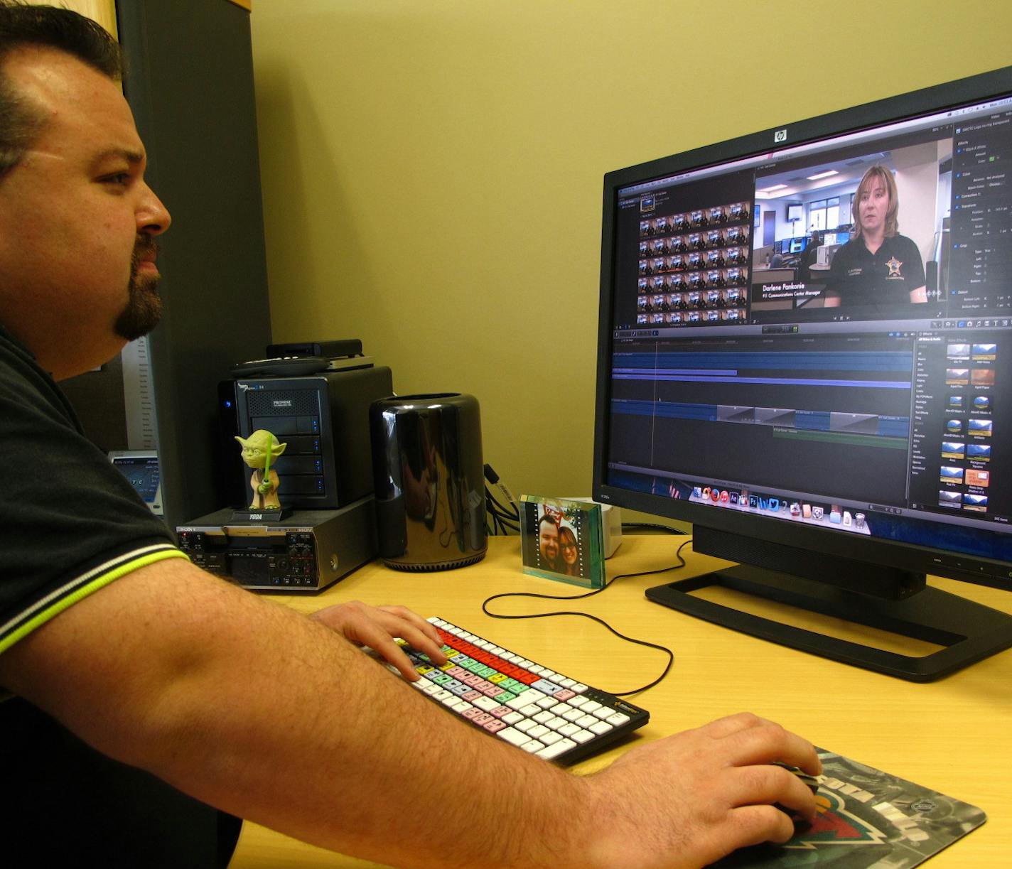 Justin Atkinson, a producer for South Washington County Telecommunications Commission, edits a video.