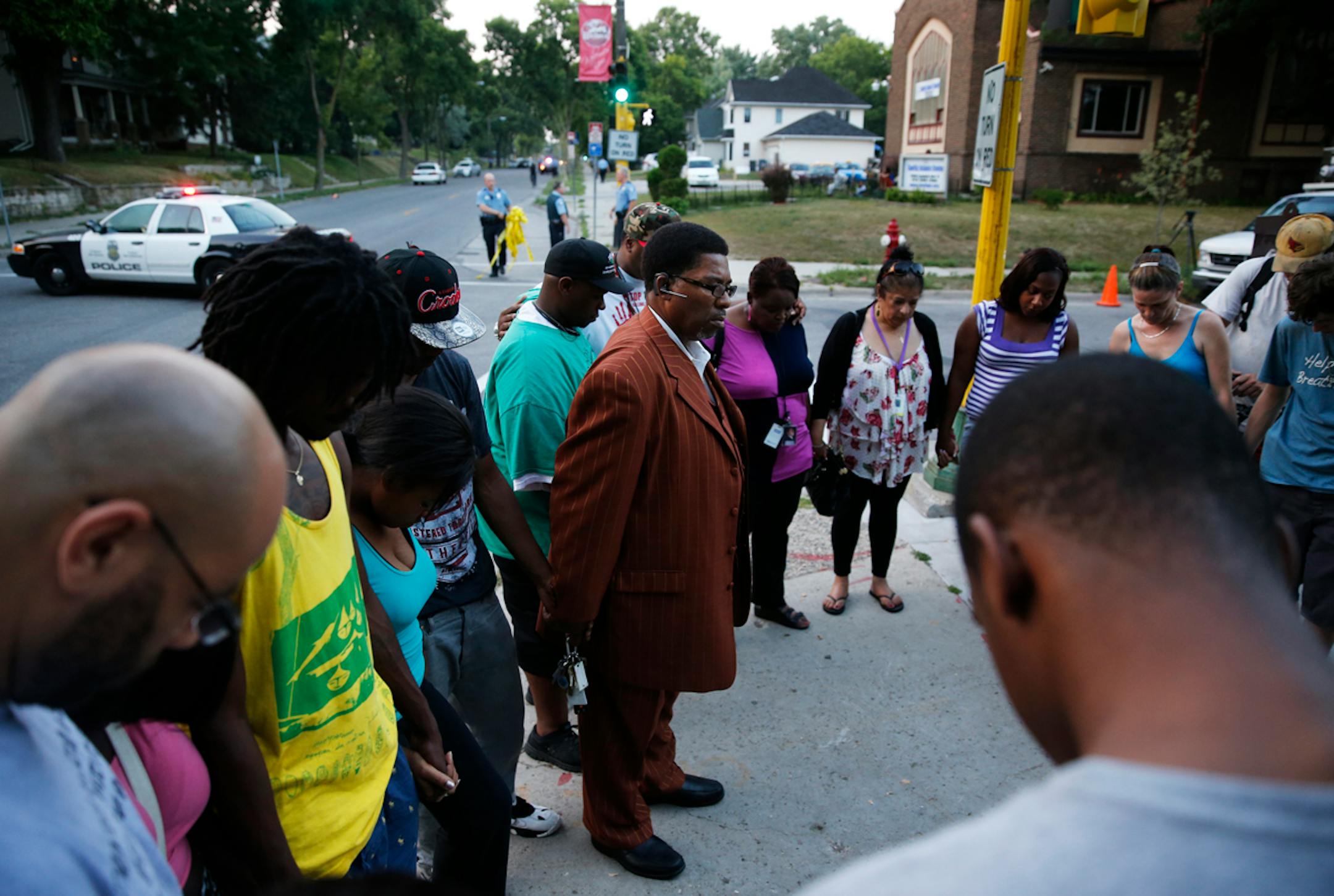 On Lyndale Avenue N. between 29th and 30th, police investigated the area where three people were shot in the early evening hours. V.J. Smith held a prayer for the victims.
