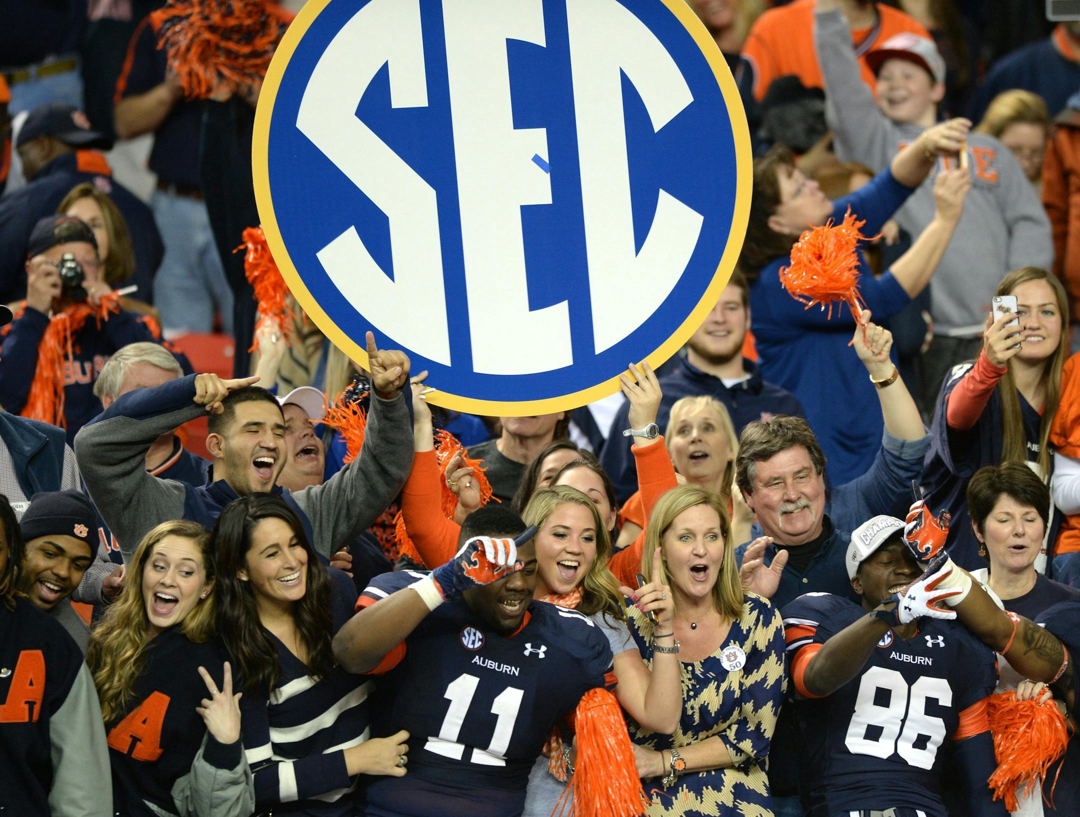 Auburn tight end Brandon Fulse (11) and wide receiver Dimitri Reese (86) celebrate with fans after a 59-42 victory against Missouri in the SEC Championship game at the Georgia Dome in Atlanta, Saturday, Dec. 7, 2013. (Hyosub Shin/Atlanta Journal-Constitution/MCT)