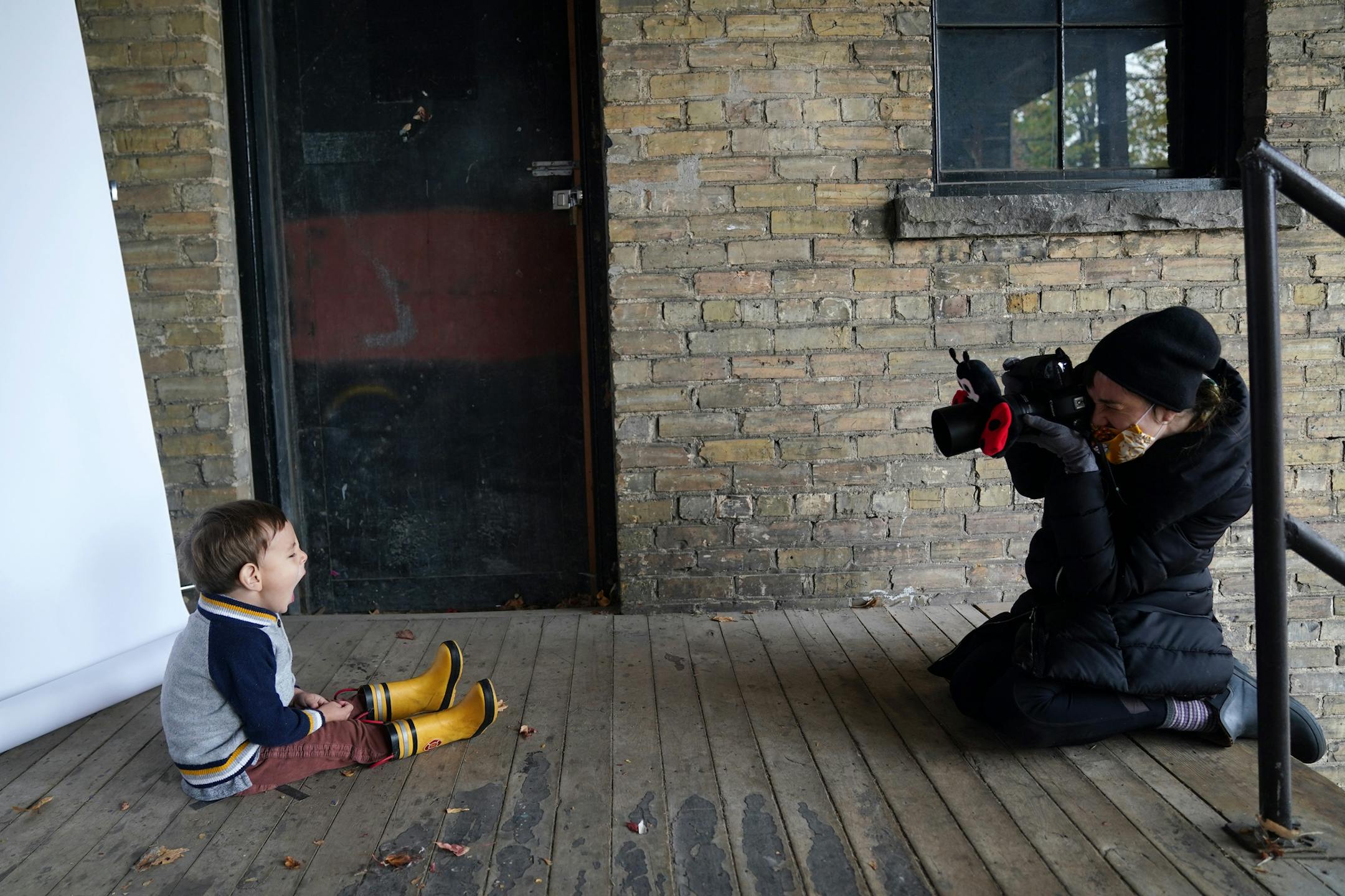 Minneapolis photographer Alison Malone took "school picture" style photos of Miles Kazama, 2, outside her studio. ] ANTHONY SOUFFLE • anthony.souffle@startribune.com Minneapolis photographer Alison Malone took "school picture" style portraits outside her studio for kids whose schools are in distance learning but whose parents still want school pictures Saturday, Oct. 24, 2020 in northeast Minneapolis.