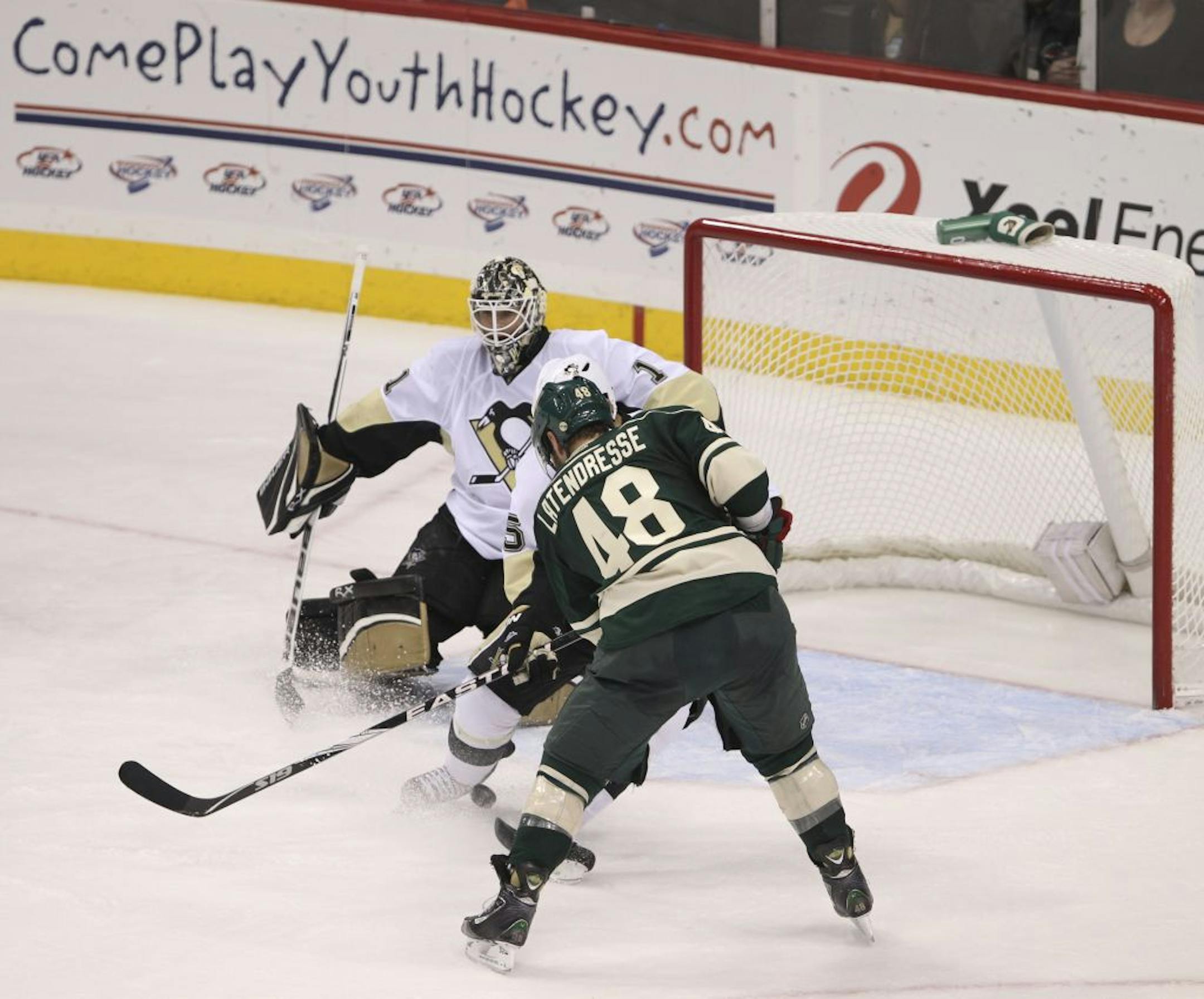 Minnesota's Guillaume Latendresse slipped a third period shot past Pittsburgh defenseman Deryk Engelland to score on goaltender Brent Johnson. The Minnesota Wild lost 4-2 to the Pittsburgh Penguins in an NHL hockey game Tuesday night, October 18, at Xcel Energy Center in St. Paul, MInn.