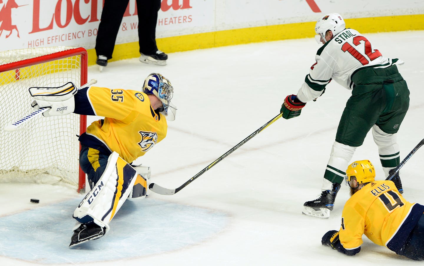 Minnesota Wild center Eric Staal (12) scores a goal against Nashville Predators goaltender Pekka Rinne (35), of Finland, during the third period of an NHL hockey game Tuesday March 27, 2018, in Nashville, Tenn. (AP Photo/Mark Zaleski)