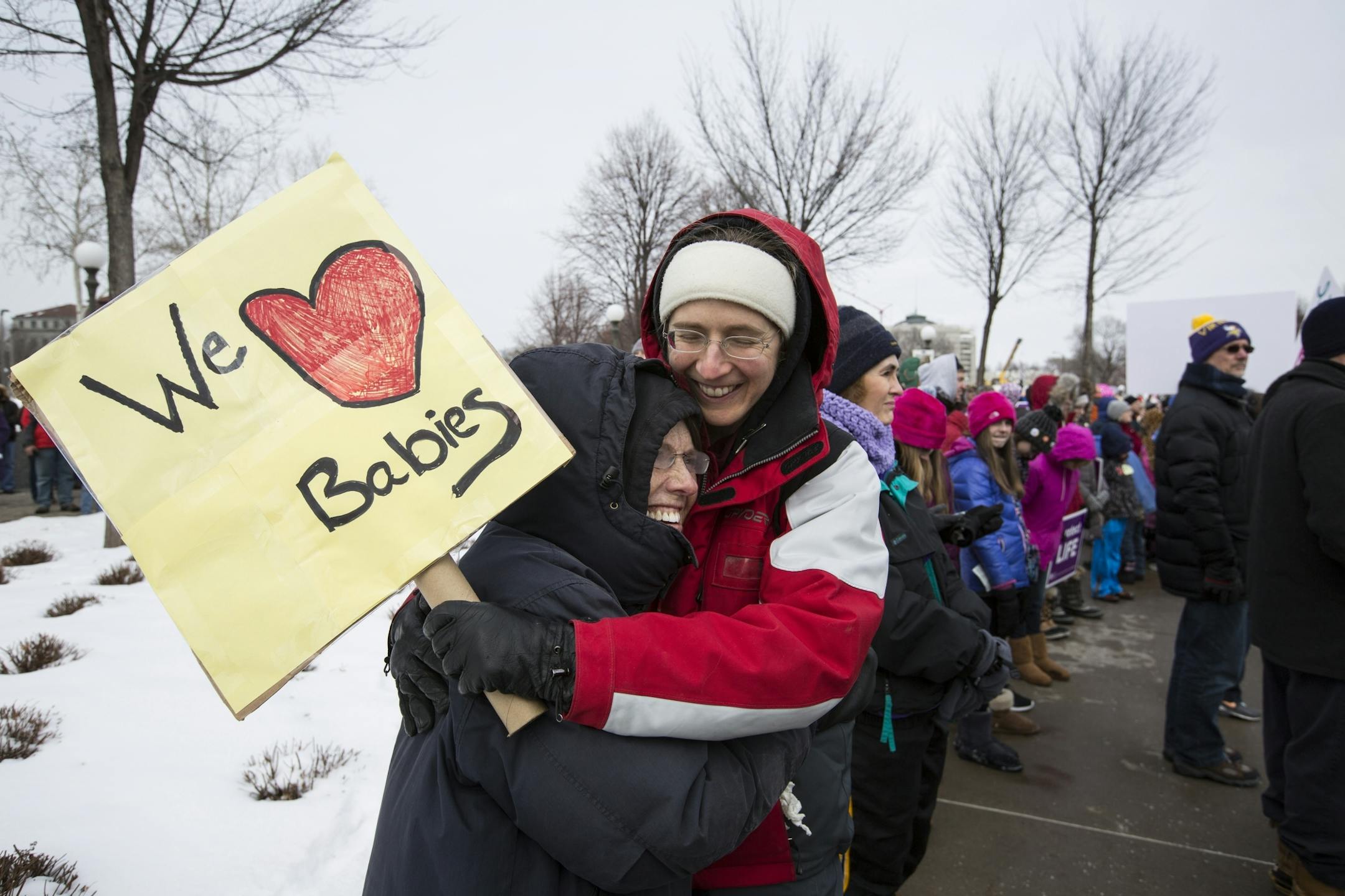 Caileen Kromhout, right, of St. Paul gets a hug from her godmother Alice Olson of Forrest Lake during the annual Minnesota Citizens Concerned for Life March for Life at the State Capitol Mall in St. Paul on Friday, January 22, 2016.