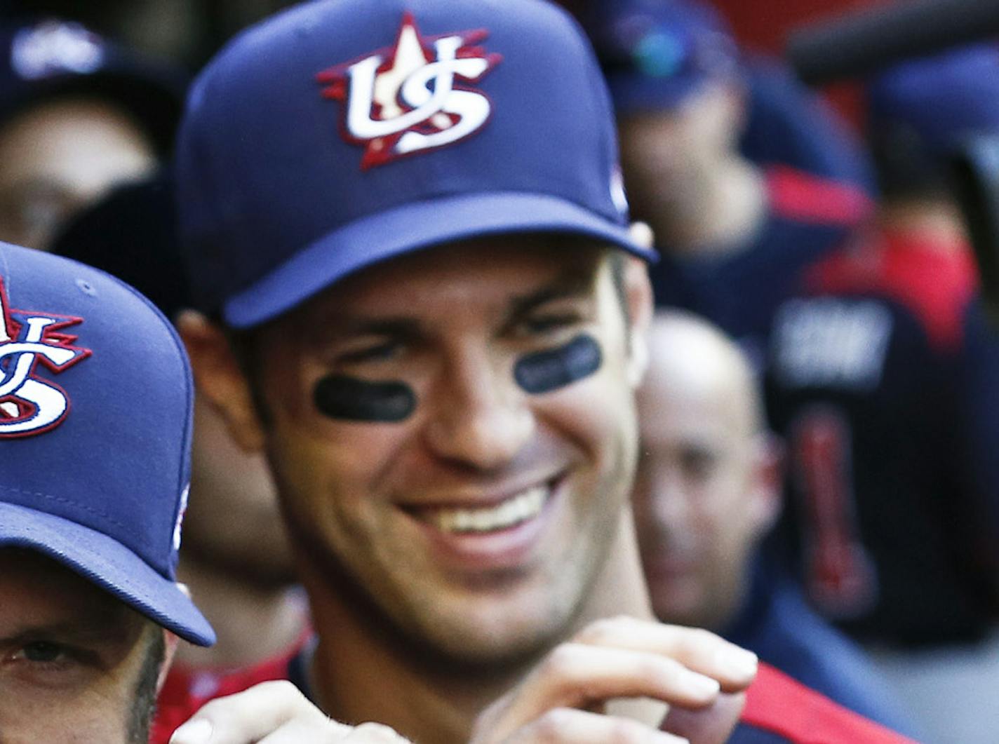 United States' Heath Bell (21) and Joe Mauer, second from left, celebrate a win over Canada with high-fives after a World Baseball Classic baseball game on Sunday, March 10, 2013, in Phoenix. The United States defeated Canada 9-4. (AP Photo/Ross D. Franklin) ORG XMIT: MIN2013031719525513