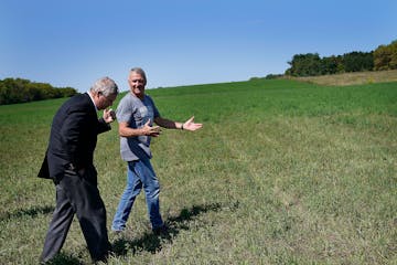 Agriculture Secretary Tom Vilsack, left, walked with farmer William “Chip” Callister Thursday in what should be a knee-high third crop of alfalfa 