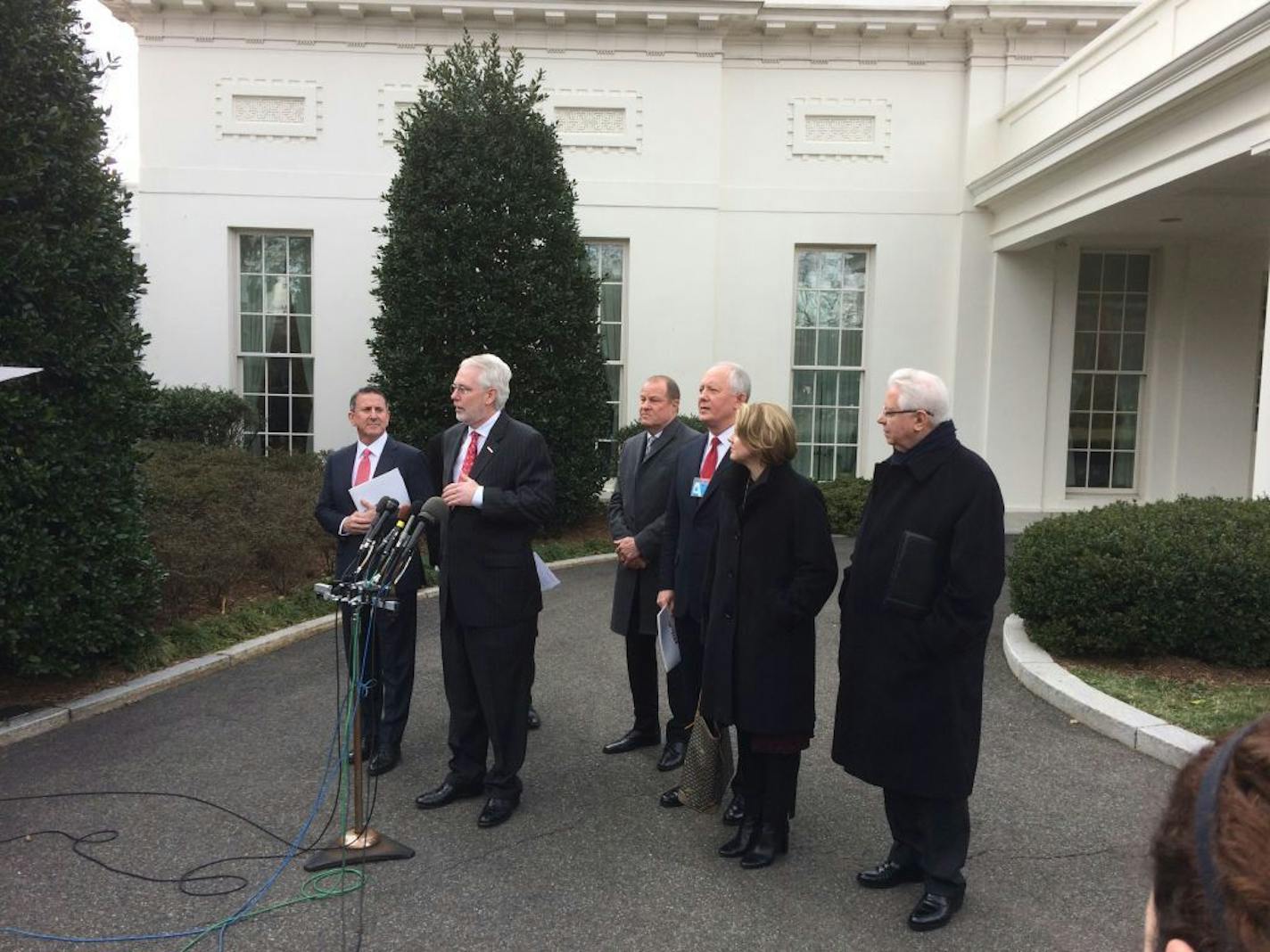 Bill Rhode,s CEO AutoZone, speaks to media at the White House Wednesday. Target CEO Brian Cornell is at far left. The retail executives met with President Trump to discuss their concerns about a possible border adjustment tax.