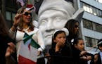 FILE - In this Oct. 12, 2015, file photo, participants in the Columbus Day Parade ride a float with a large bust of Christopher Columbus in New York. 