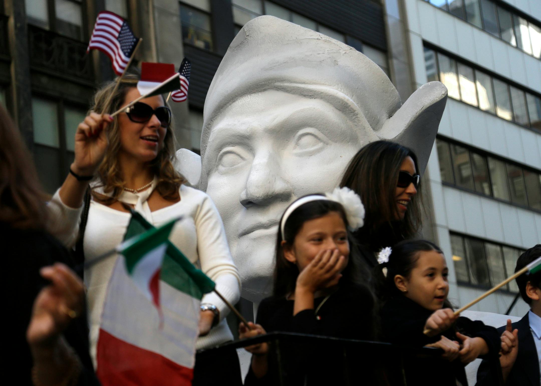FILE - In this Oct. 12, 2015, file photo, participants in the Columbus Day Parade ride a float with a large bust of Christopher Columbus in New York. A movement to abolish Columbus Day and replace it with Indigenous Peoples Day has new momentum but the gesture to recognize victims of European colonialism has also prompted howls of outrage from some Italian Americans, who say eliminating their festival of ethnic pride is culturally insensitive, too. (AP Photo/Seth Wenig)