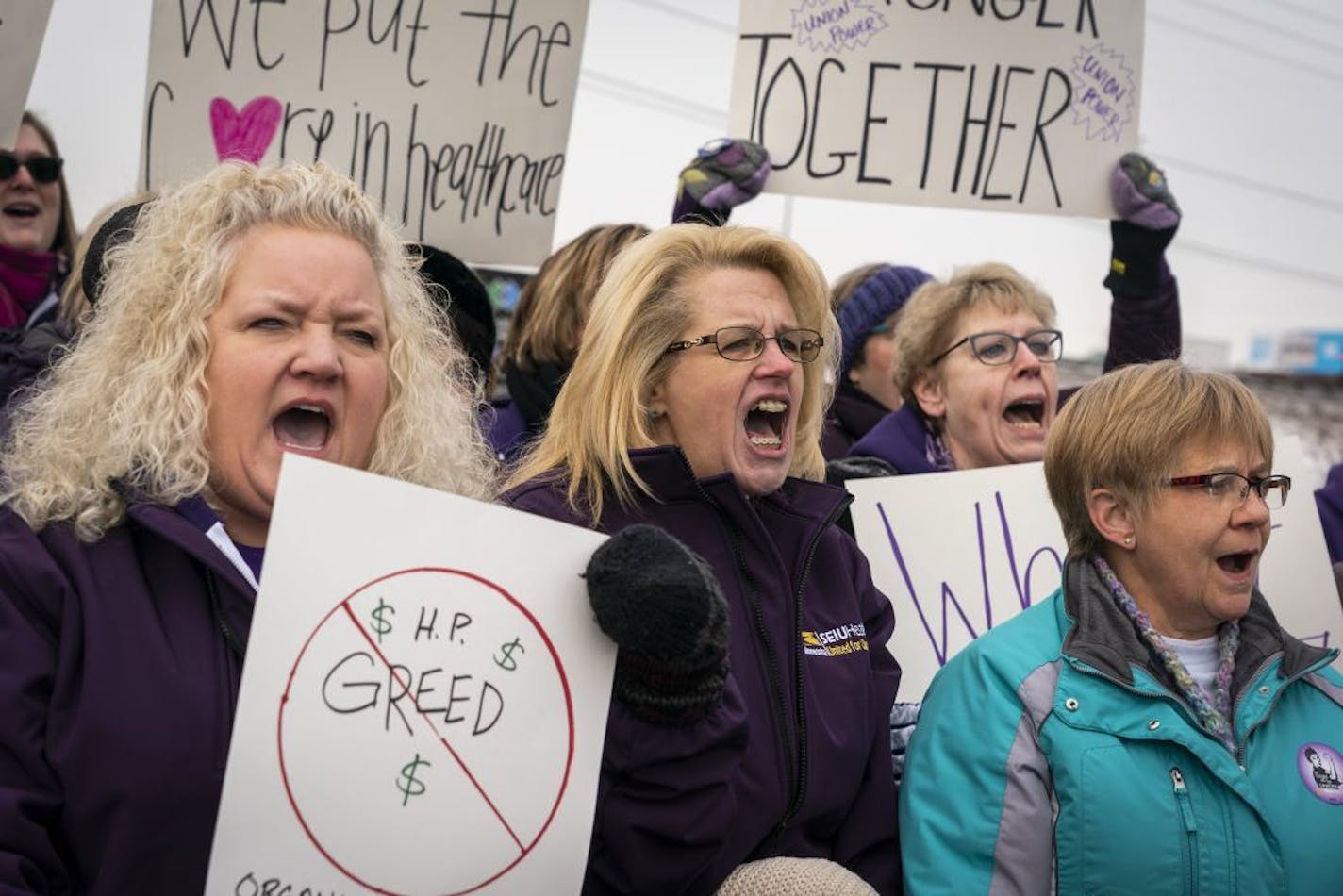 Constance Swets, center, a HealthPartners Clinic lab assistant and SEIU union steward, chants with Anna Grimes, left, a medical lab technician and member of the SEIU bargaining committee, during the press conference.