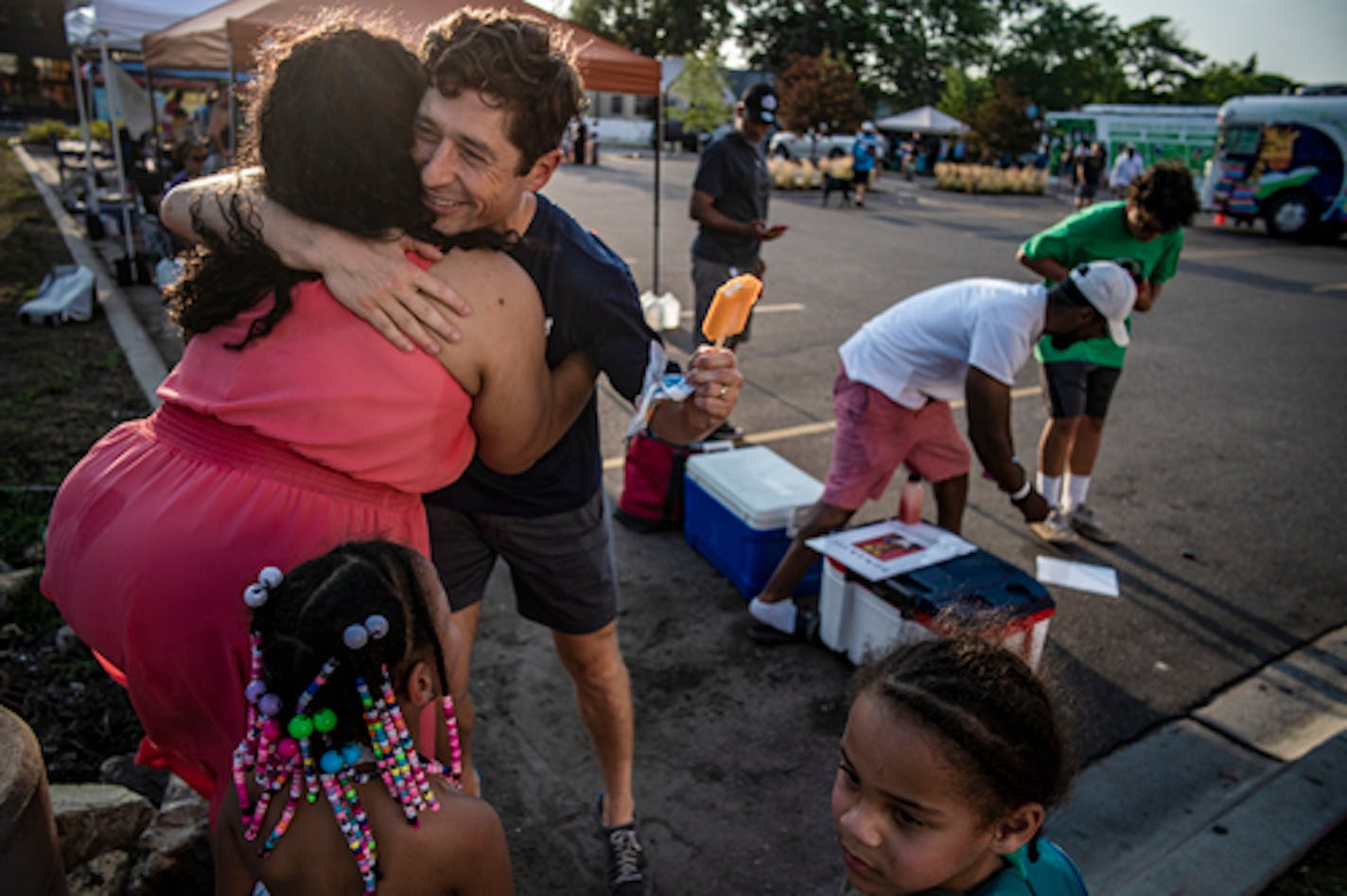 Mayor Jacob Frey gives a big hug to supporter Rochelle Washington who is with her twins Kymora and Carmeli, both 5, in Minneapolis, Minn., on Tuesday, Aug. 2, 2022. Frey's planning to end the night at The Get Down Coffee Company, where there will be an event with Fourth Ward Council Member LaTrisha Vetaw. ] RICHARD TSONG-TAATARII • richard.tsong-taatarii@startribune.com