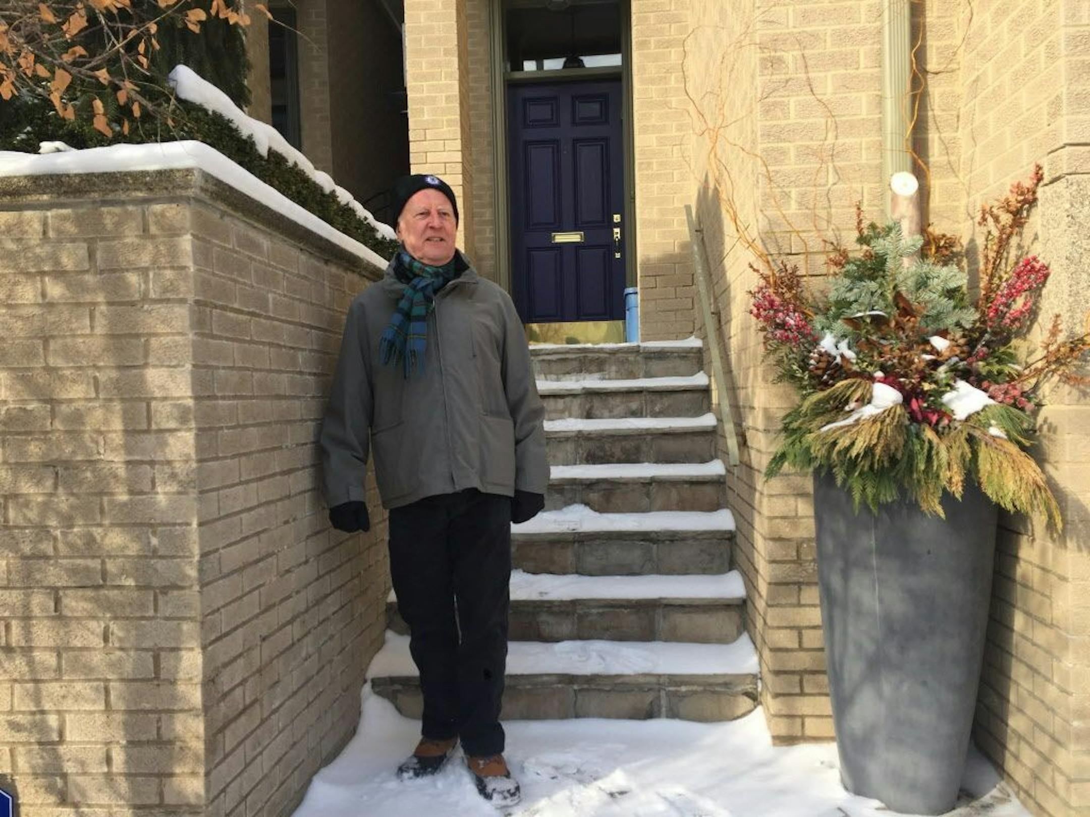 In this Jan. 31, 2018 photo, property owner Vian Ewart stands by a planter that police investigated at his town house in the Yonge and St. Clair neighborhood of Toronto, Canada. Ewart quickly figured out why police showed up at his elegant town house with a cadaver dog to search the waist-high stone planter at his doorstep: his landscaper Bruce McArthur is a suspected serial killer.