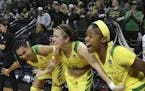Oregon's Satou Sabally, left, Sabrina Ionescu and Ruthy Hebard, right, come off the bench in celebration of the team's 78-40 victory over Portland Sta