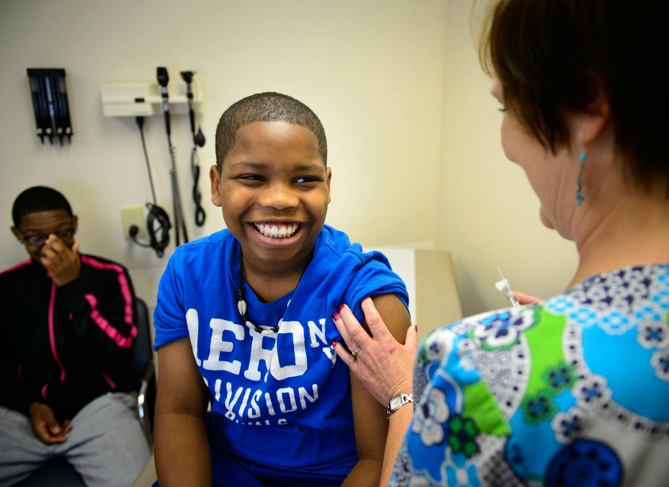 Courtney Carter, 12, received two vaccinations from LPN Kathy Schwalbe at Park Nicollet Clinic‚ÄîBrookdale in Brooklyn Center. On the left is brother Christopher, 16. ] Brooklyn Center , MN -- Monday, August 25, 2014. GLEN STUBBE * gstubbe@startribune.com