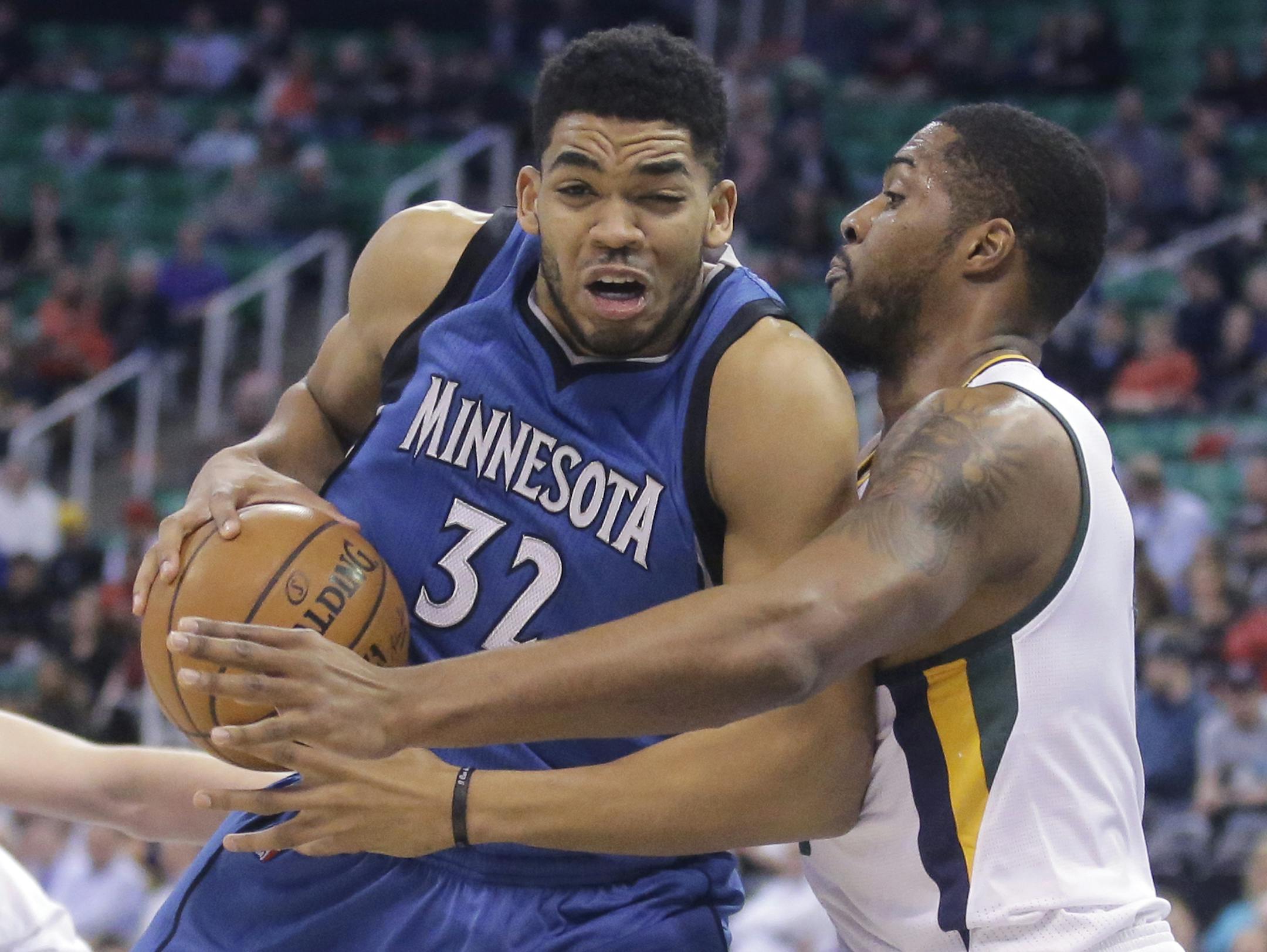 Utah Jazz forward Derrick Favors, right, defends against Minnesota Timberwolves center Karl-Anthony Towns (32) during the first half in an NBA basketball game Wednesday, March 1, 2017, in Salt Lake City. (AP Photo/Rick Bowmer)