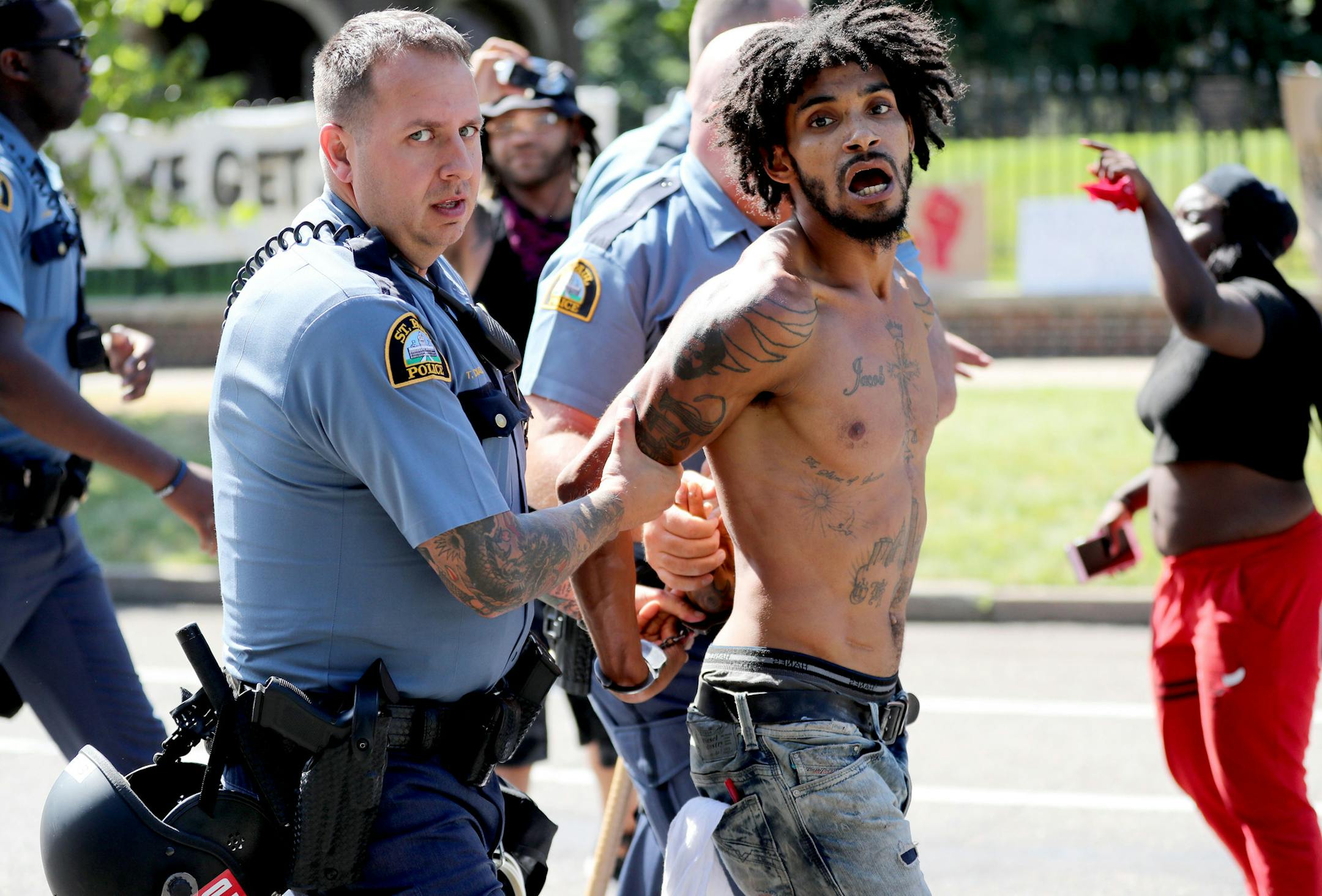 After St. Paul police officers moved in on protestors one of the movements leaders Jacob Ladda is taken away in handcuffs Tuesday, July 26, 2016, in front of Gov. Mark Dayton's mansion in St. Paul, MN.](DAVID JOLES/STARTRIBUNE)djoles@startribune Protesters were ordered Tuesday to clear the street and sidewalk in front of the governor's residence, where they have been since the fatal police shooting of Philando Castile nearly three weeks ago in neighboring Falcon Heights.**Wesley Martin,,cq