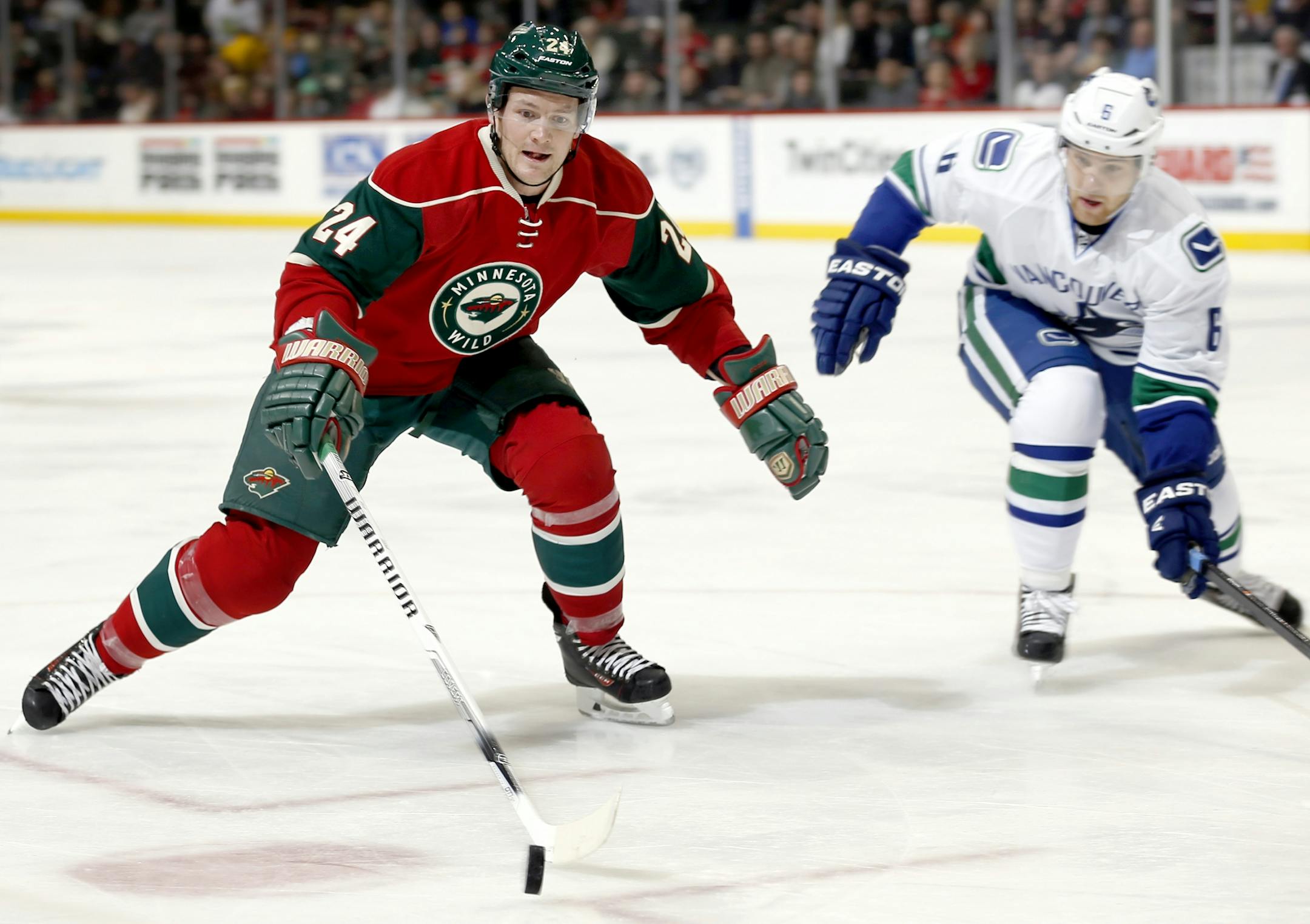 Matt Cooke (24) and Yannick Weber (6) chased a loose puck in the first period.