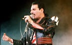 FILE - In this 1985 file photo, singer Freddie Mercury of the rock group Queen, performs at a concert in Sydney, Australia. Queen guitarist Brian May 