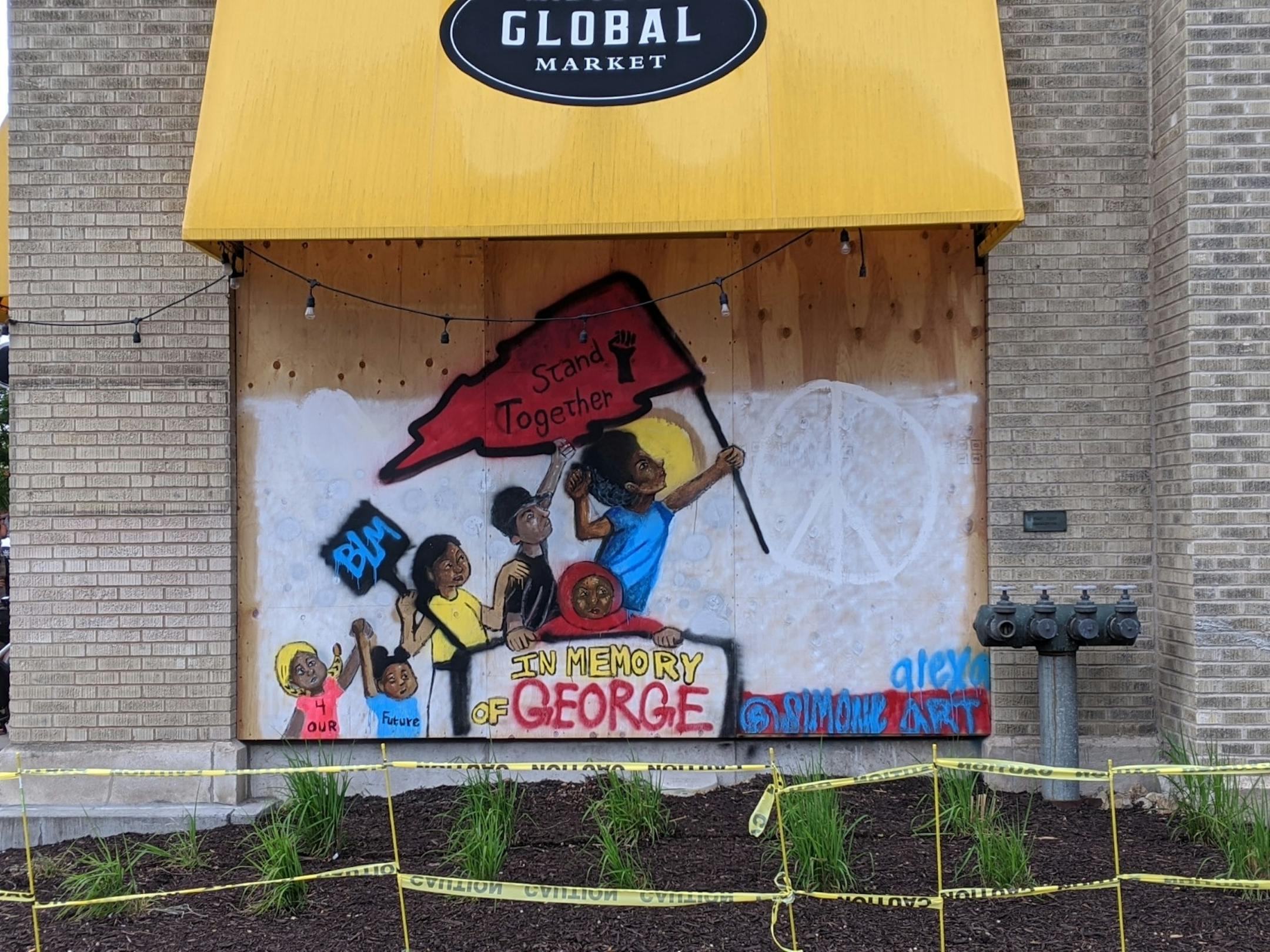 A mural by @SimoneAlexaArt on Midtown Global Market offers messages of remembrance for George Floyd, support of Black Lives Matter, and hope for the future.