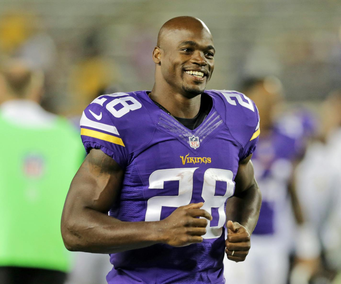 FILE - In this Aug. 8, 2014, file photo, Minnesota Vikings running back Adrian Peterson leaves the field after an NFL preseason football game against the Oakland Raiders in Minneapolis. The NFL has reinstated Minnesota Vikings running back Adrian Peterson, clearing the way for him to return after missing most of last season while facing child abuse charges in Texas. The league announced its decision on Thursday, April 16, 2015. (AP Photo/Jim Mone, File)