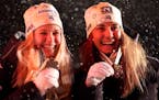 Americans Jessie Diggins and Julia Kern posed on the podium with their bronze medals during the medal ceremony for the women's cross country team spri