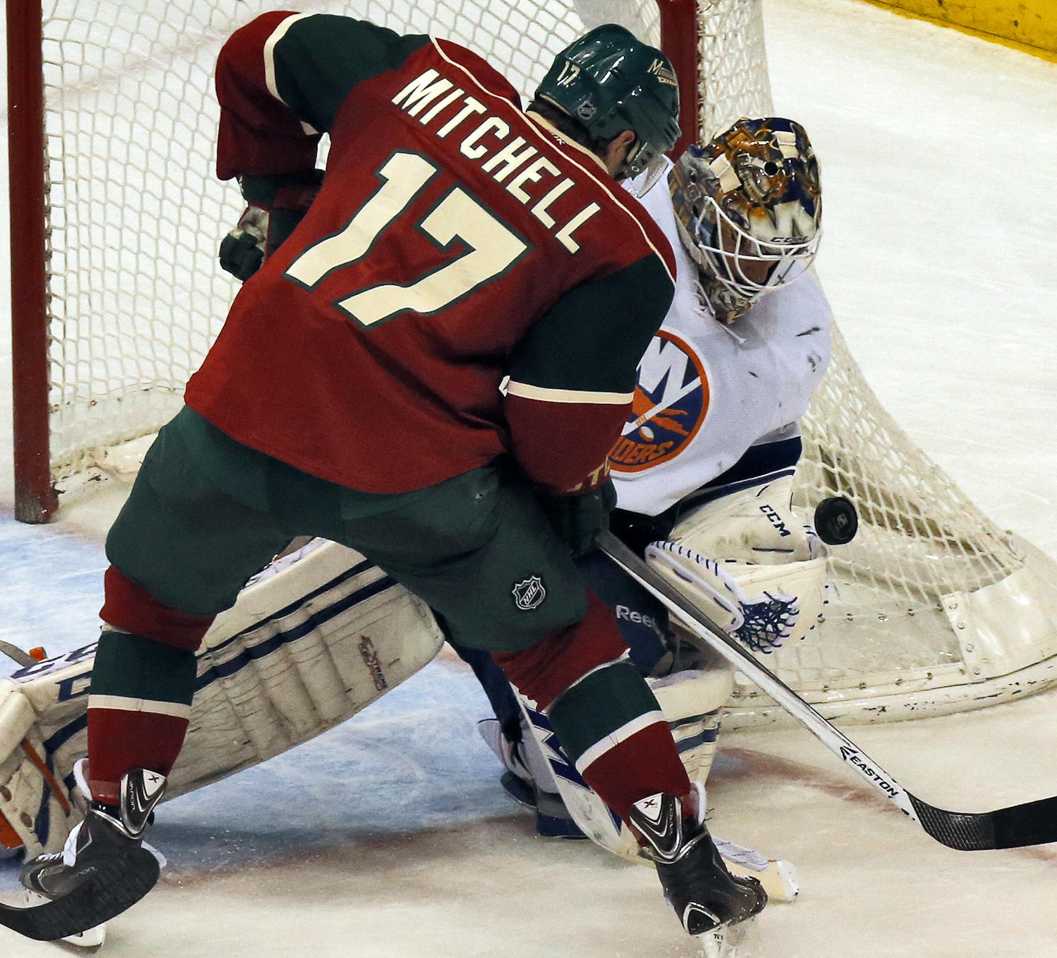 Minnesota Wild vs. New York Islanders. Wild Torrey Mitchell did battle with Islander goalie Kevin Poulin. (MARLIN LEVISON/STARTRIBUNE(mlevison@startribune.com)