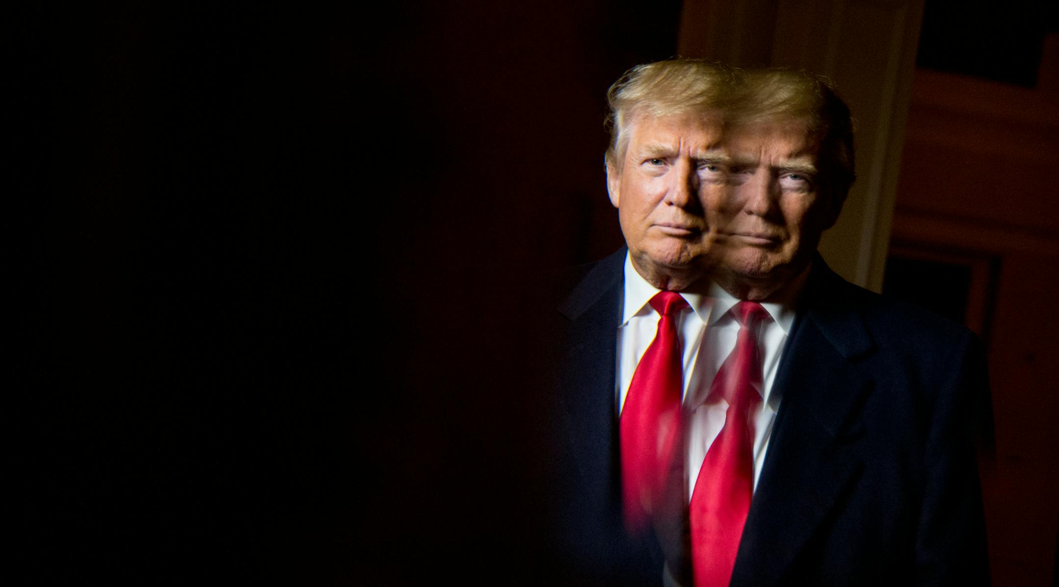 Republican presidential candidate Donald Trump, seen in reflection, poses for a portrait following an interview with the Associated Press at the Trump National Golf Club in Sterling, Va., Wednesday, Dec. 2, 2015. Trump says that if heís elected president, heíll know within six months whether he can achieve an elusive peace accord between Israelis and Palestinians, one of the worldís most vexing challenges. But the Republican presidential candidate says he has doubts about each sid