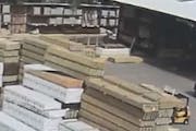 A photo from surveillance video released by Golden Valley police shows the forklift, at right, before the lumber fell.