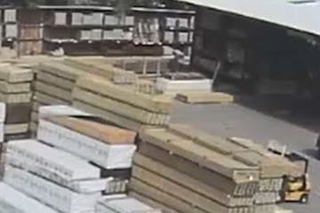 A photo from surveillance video released by Golden Valley police shows the forklift, at right, before the lumber fell.