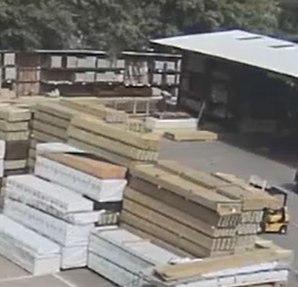 A photo from surveillance video released by Golden Valley police shows the forklift, at right, before the lumber fell.