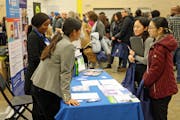 Ekta Prakash and Akiatu Pratt of the Department of Employment and Economic Development talked with prospective workers Cha Her of St. Paul and Nuhchi 