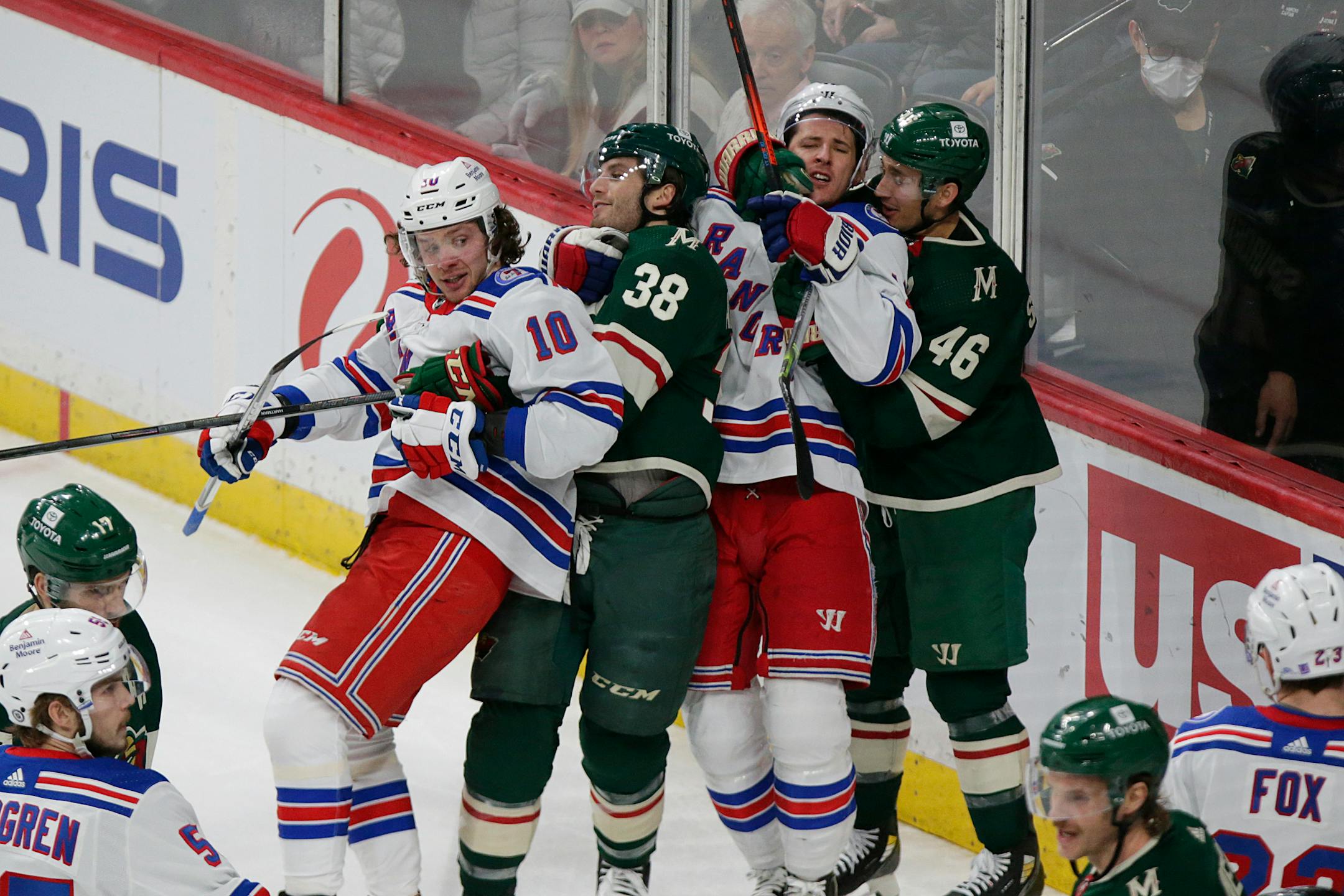 New York Rangers left wing Artemi Panarin (10), Minnesota Wild right wing Ryan Hartman (38), New York Rangers center Ryan Strome (16) and Minnesota Wild defenseman Jared Spurgeon (46) use mutual restraint during a skirmish during an NHL hockey game Tuesday, March 8, 2022, in St. Paul, Minn. (AP Photo/Andy Clayton-King)