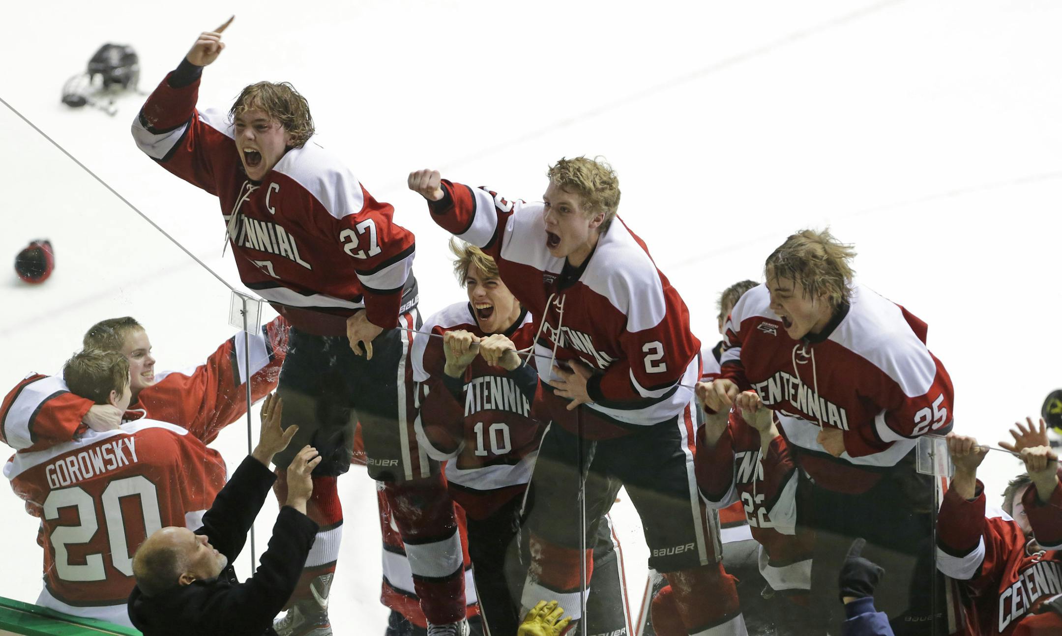 Centennial players jump on the glass in front of their fans after beating Blaine 2-1 during the second period of boys hockey section 5AA finals in Falcon Heights, Friday, Feb. 28, 2014. ( Photo/Ann Heisenfelt) ORG XMIT: 7059 PREP030114puck 5