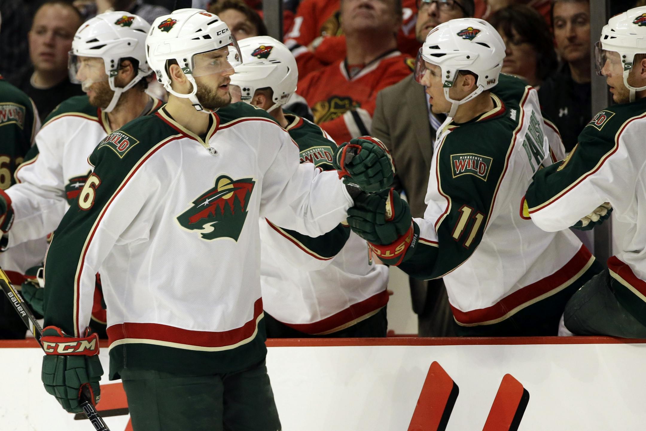 Minnesota Wild's Marco Scandella (6) celebrates with teammates after scoring a goal against the Chicago Blackhawks during the second period of Game 5 of an NHL hockey Stanley Cup first-round playoff series in Chicago, Thursday, May 9, 2013.
