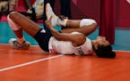 Jordan Thompson lies on the court after an injury during the women's volleyball preliminary round pool B match between United States and Russian Olymp