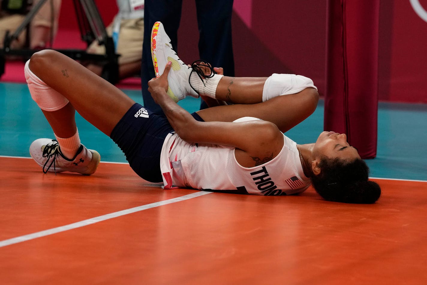 Jordan Thompson lies on the court after an injury during the women's volleyball preliminary round pool B match between United States and Russian Olympic Committee