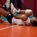 Jordan Thompson lies on the court after an injury during the women's volleyball preliminary round pool B match between United States and Russian Olymp
