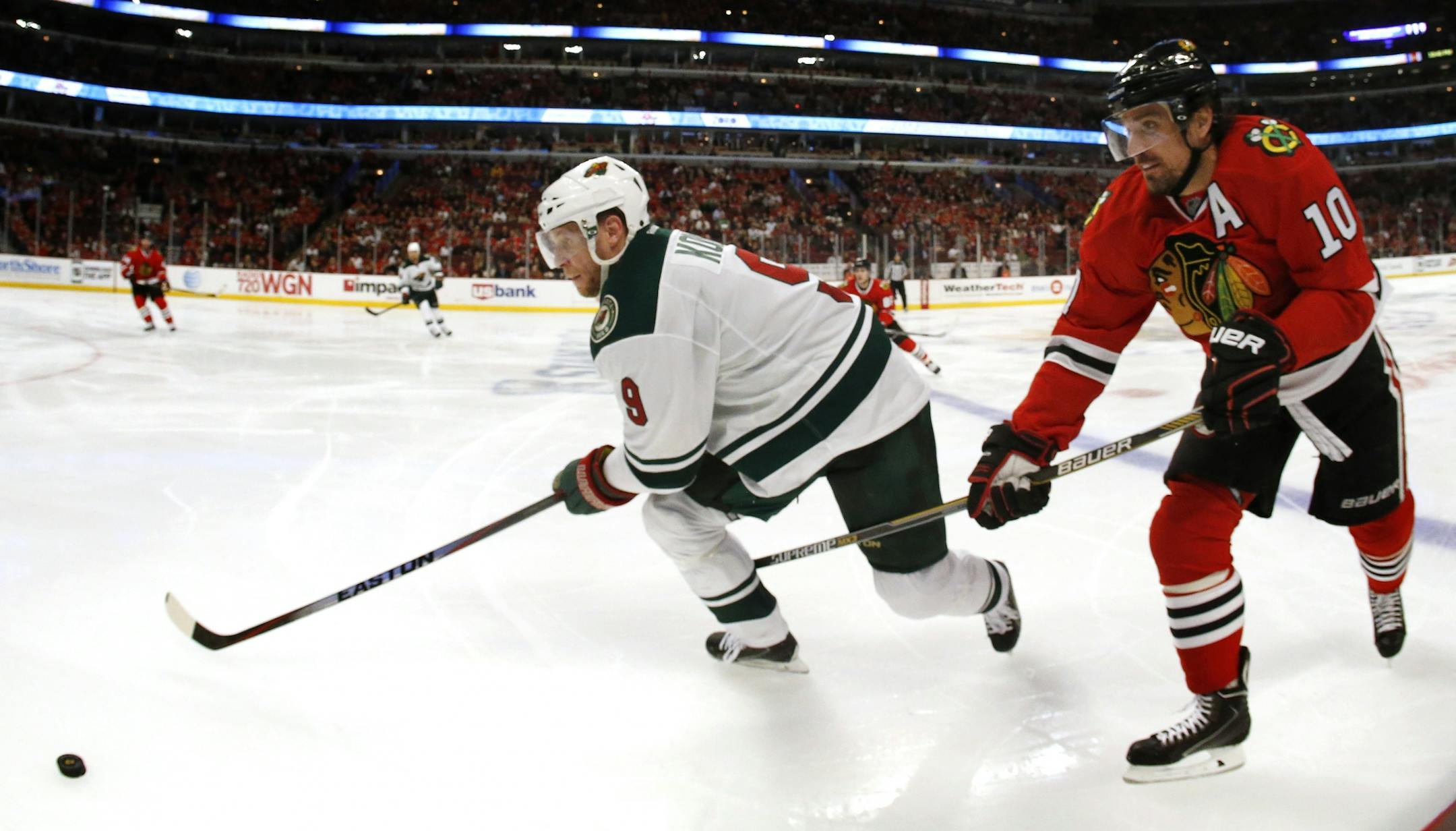 Mikko Koivu (9) and Patrick Sharp (10) fought for the puck in the third period.