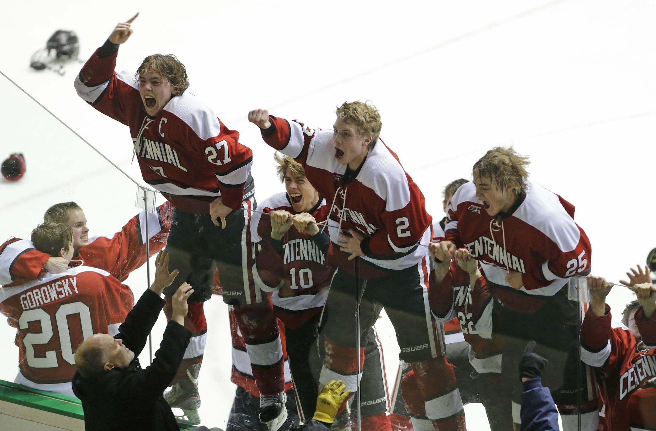 Centennial players jump on the glass in front of their fans after beating Blaine 2-1 during the second period of boys hockey section 5AA finals in Falcon Heights, Friday, Feb. 28, 2014. ( Photo/Ann Heisenfelt) ORG XMIT: 7059 PREP030114puck 5