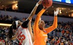 Syracuse's Bria Day (55) defends a shot by Tennessee's Bashaara Graves (12) during a women's college basketball regional final in the NCAA Tournament 